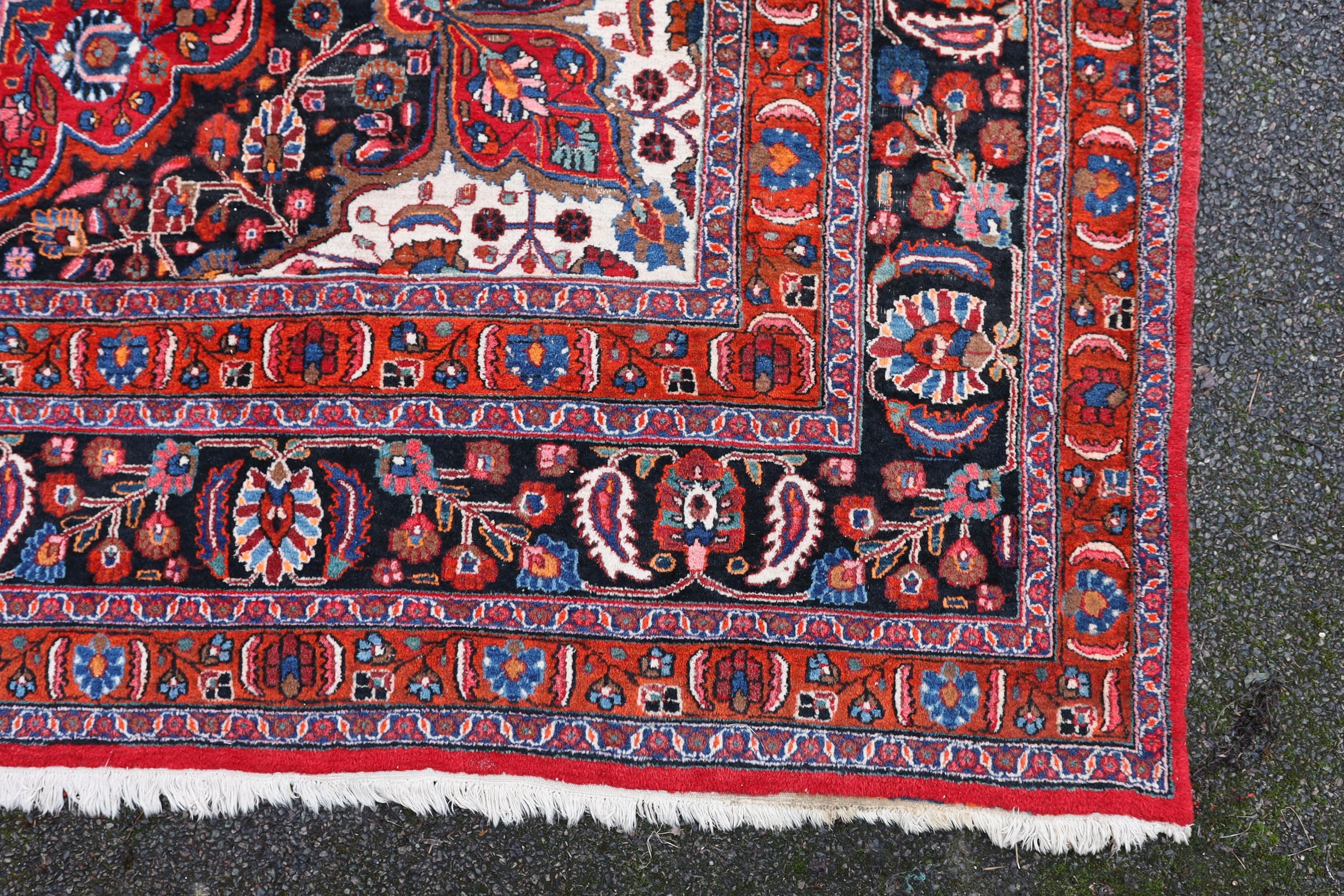 A Tabriz red ground carpet 422 x 326cm.